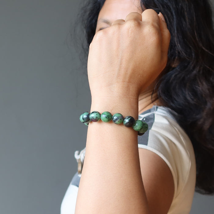 hand wearing a ruby zoisite round stretch bracelet