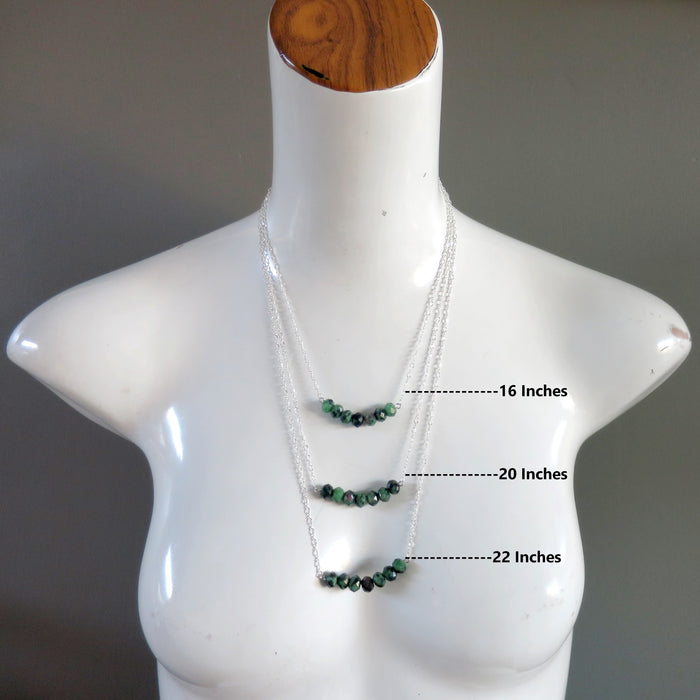 mannequin wearing layers of female wearing ruby zoisite necklaces
