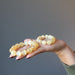 orange selenite bracelets in hand