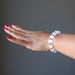 hand wearing white selenite and antique beads stretch bracelet