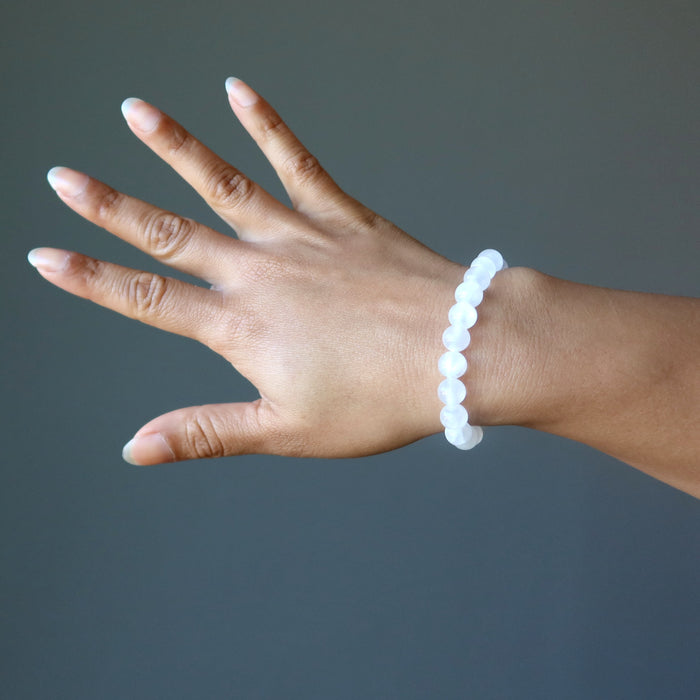 hand wearing a white selenite stretch bracelet