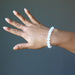 hand wearing a white selenite stretch bracelet