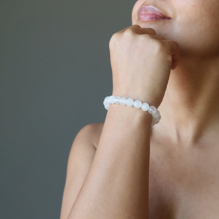hand wearing a white selenite stretch bracelet