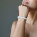 hand wearing a white selenite stretch bracelet
