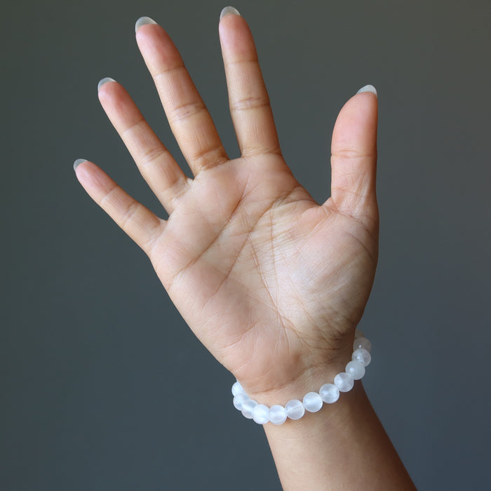 hand wearing a white selenite stretch bracelet
