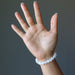 hand wearing a white selenite stretch bracelet
