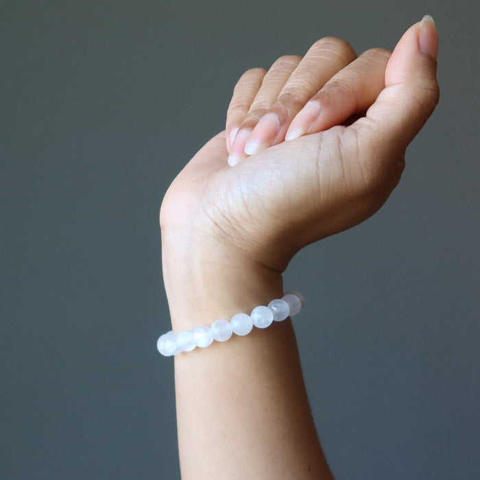 hand wearing a white selenite stretch bracelet