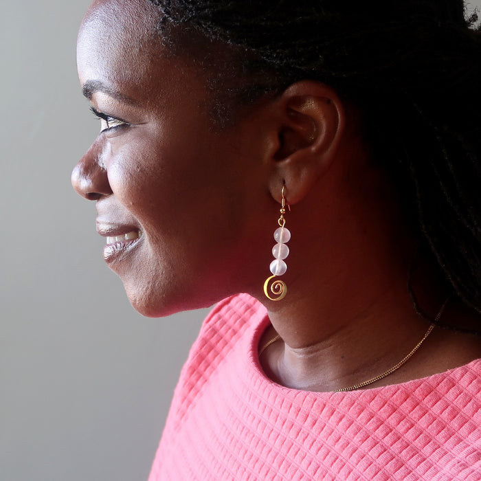 bridget  of satin crystals wearing white selenite gold spiral dangle earring
