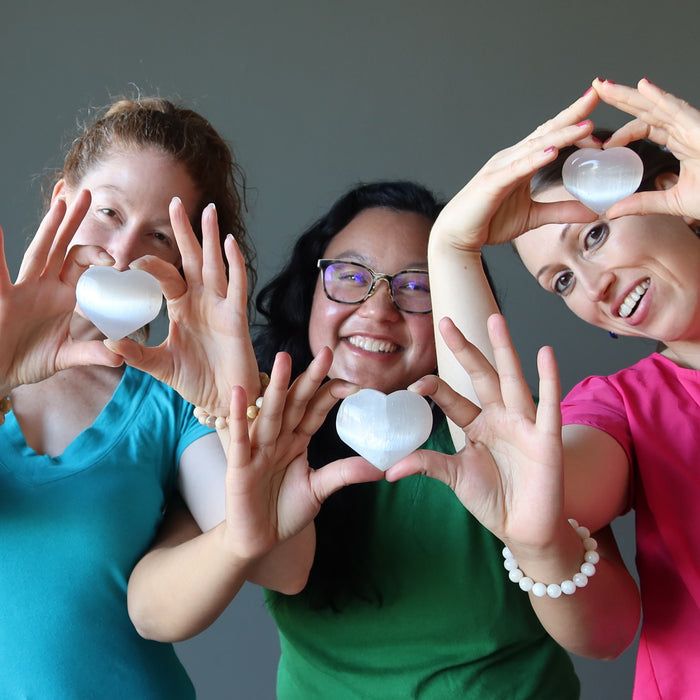 jamie, jessica and holly of satin crystals holding up a white selenite heart each