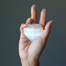 hand holding a selenite heart