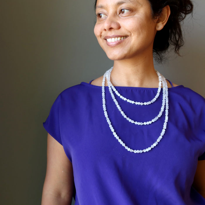 female wearing layered white selenite necklaces