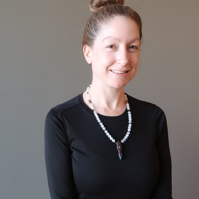 female wearing selenite goddess necklace