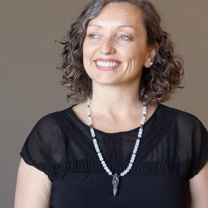 female wearing selenite goddess necklace