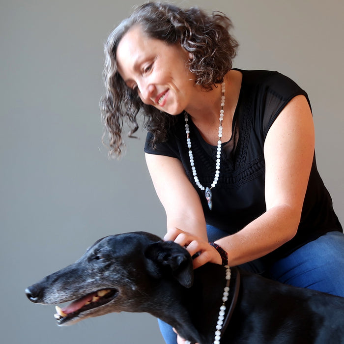 woman and dog wearing female wearing selenite goddess necklaces