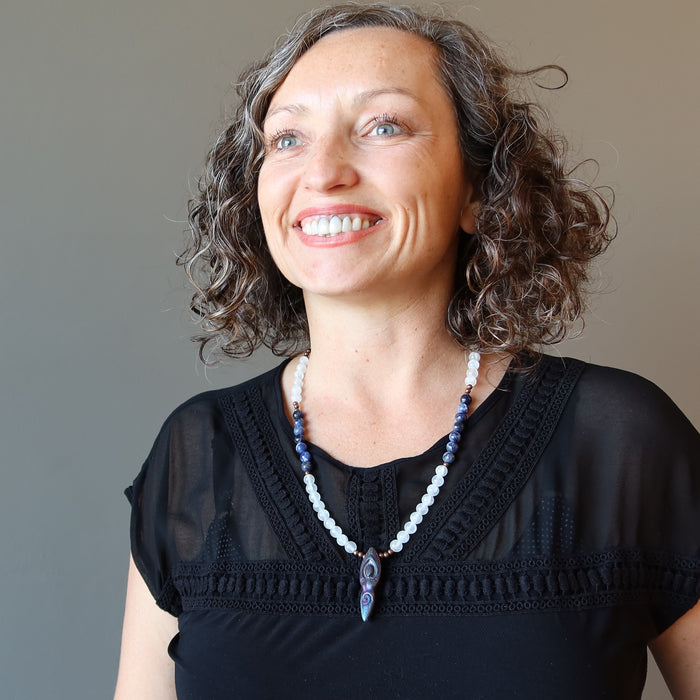 female wearing selenite sodalite goddess necklace