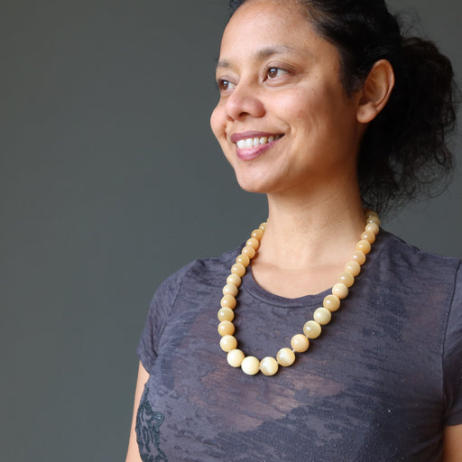 sheila of satin crystals wearing orange selenite beaded necklace