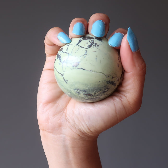 hand holding a serpentine sphere