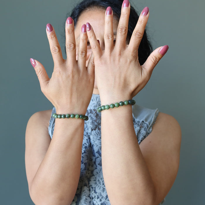 woman wearing two serpentine bracelets