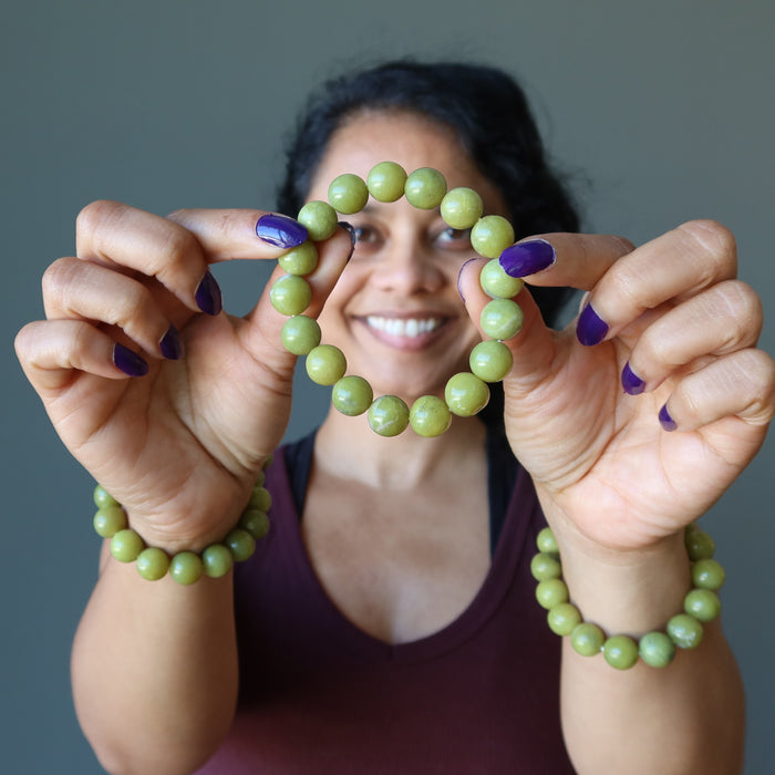woman wearing and holding serpentine stretch bracelets