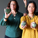 women holding asterite serpentine hearts