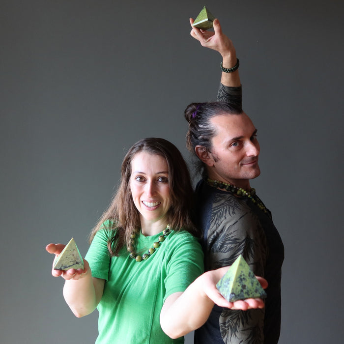 people holding serpentine pyramids