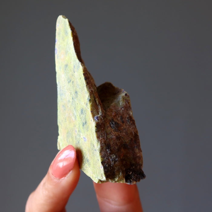 hand holding Green raw Serpentine Crystal