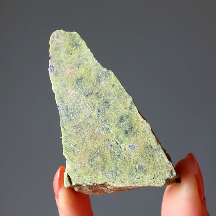 hand holding Green raw Serpentine Crystal