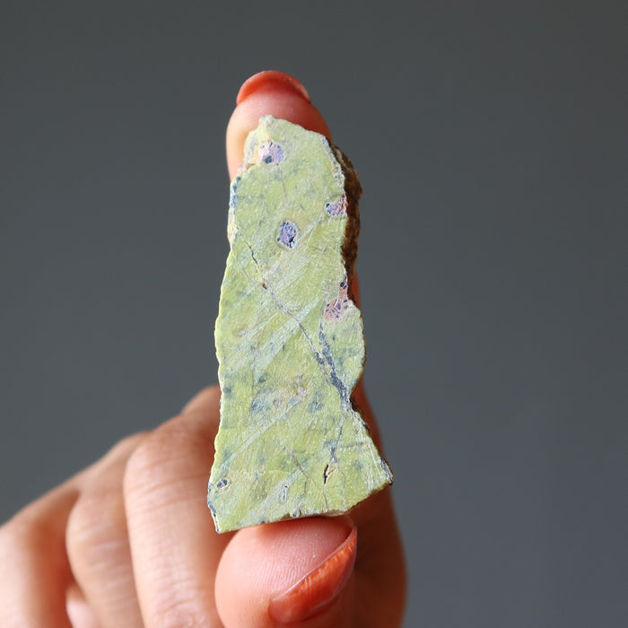 hand holding Green raw Serpentine Crystal