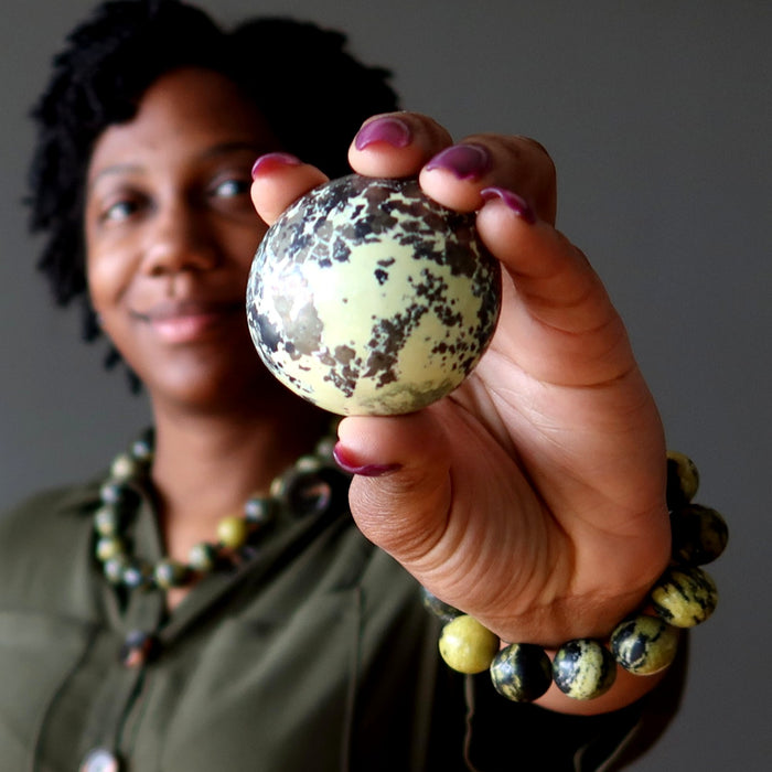 woman holding and wearing serpentine