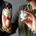 hands holding serpentine spheres