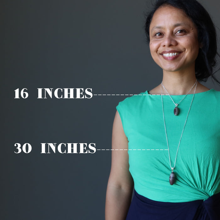 sheila of satin crystals wearing two shiva lingam necklaces showing size difference