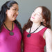 two women wearing shungite rainbow obsidian necklaces