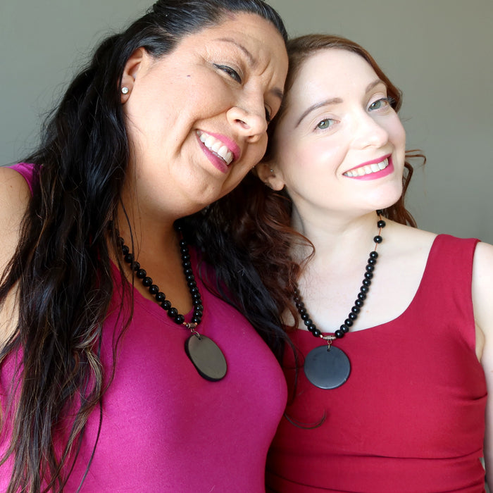 women wearing shungite rainbow obsidian necklaces
