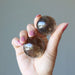 rainbow smoky quartz spheres in hand