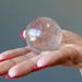 Smoky Quartz Sphere displaying on the palm
