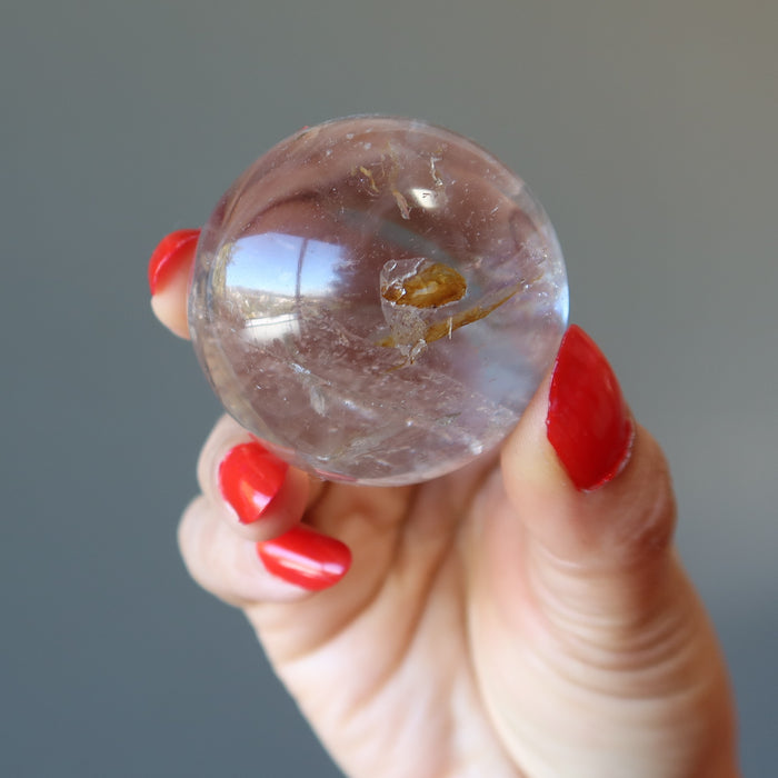 holding Smoky Quartz Sphere