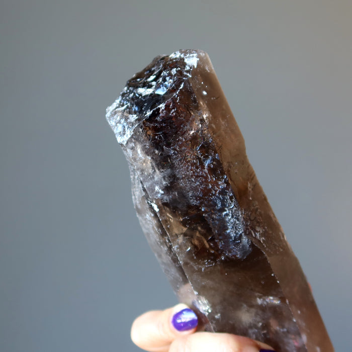 holding Smoky Quartz Point Wand
