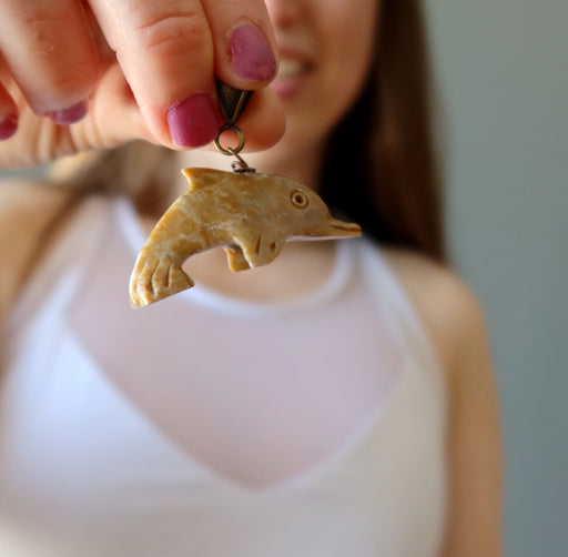 hand holding Dolphin Soapstone Pendant
