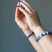 wearing sodalite bracelet on both wrists