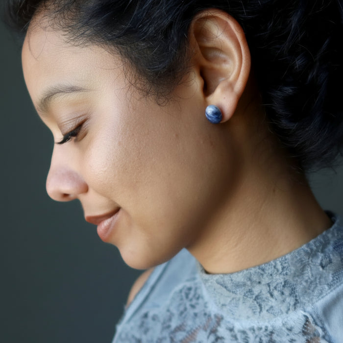 woman wearing sodalite stud earrings
