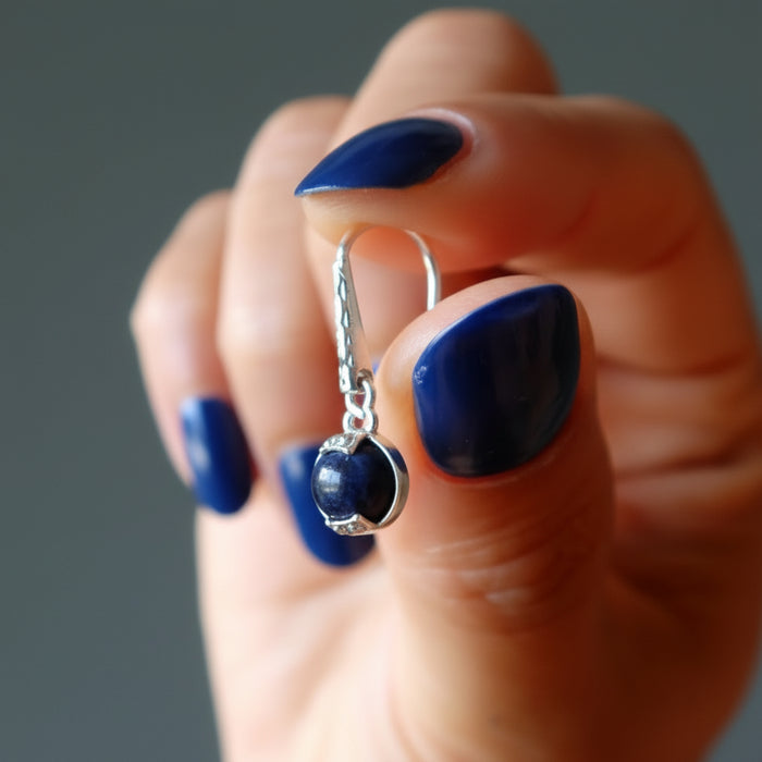 hand holding sodalite earring
