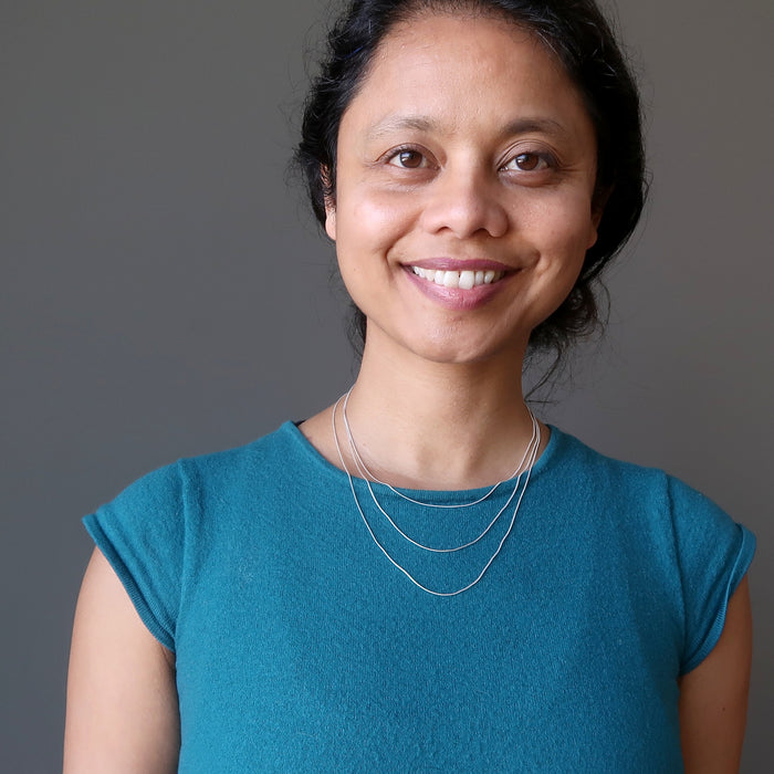 sheila of satin crystals wearing 3 sizes of sterling silver snake chain necklace