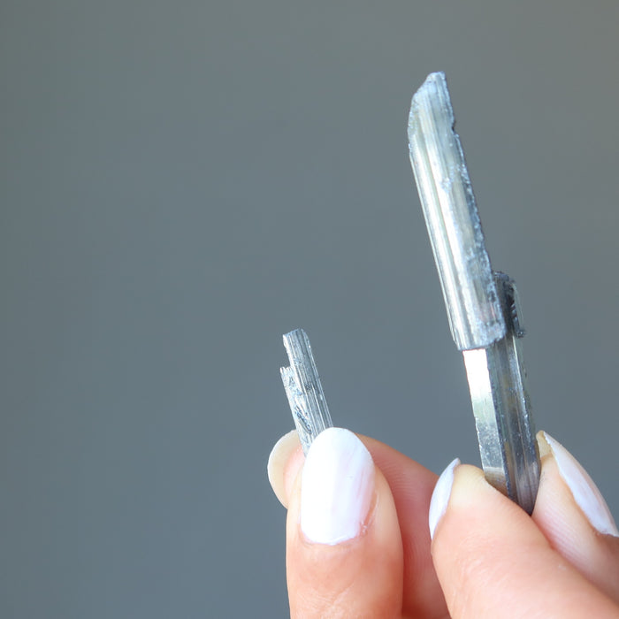 holding holding raw Stibnite wands