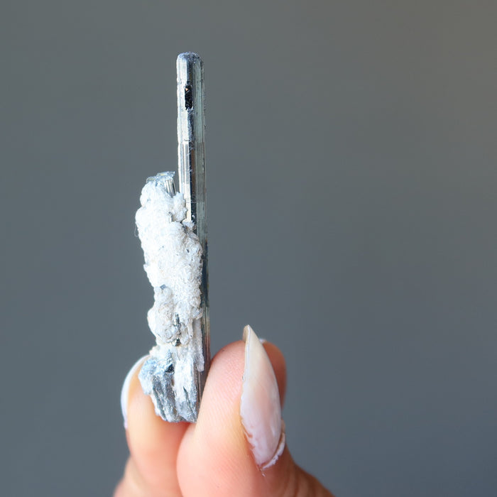 holding raw Stibnite wand 