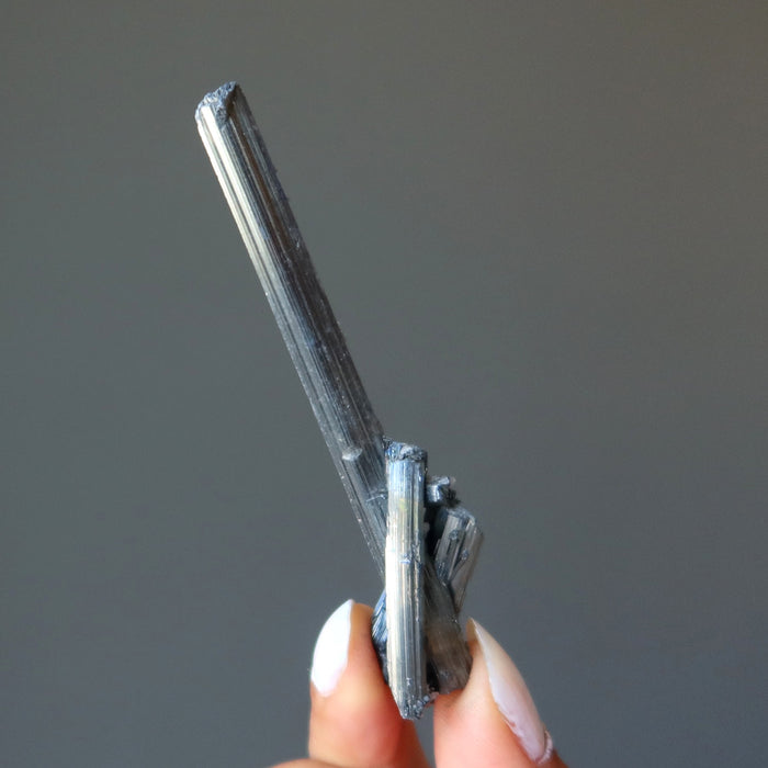 holding raw Stibnite wand 