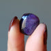 fingers holding Sugilite Polished Stone