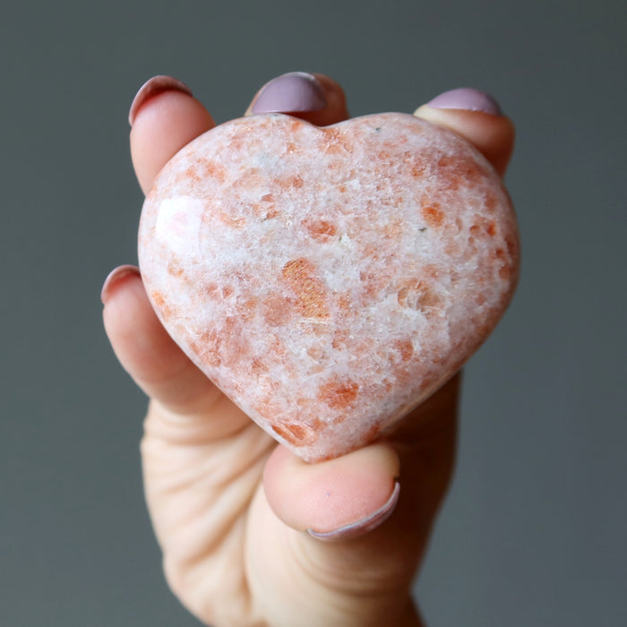 hand holding Sunstone Heart 