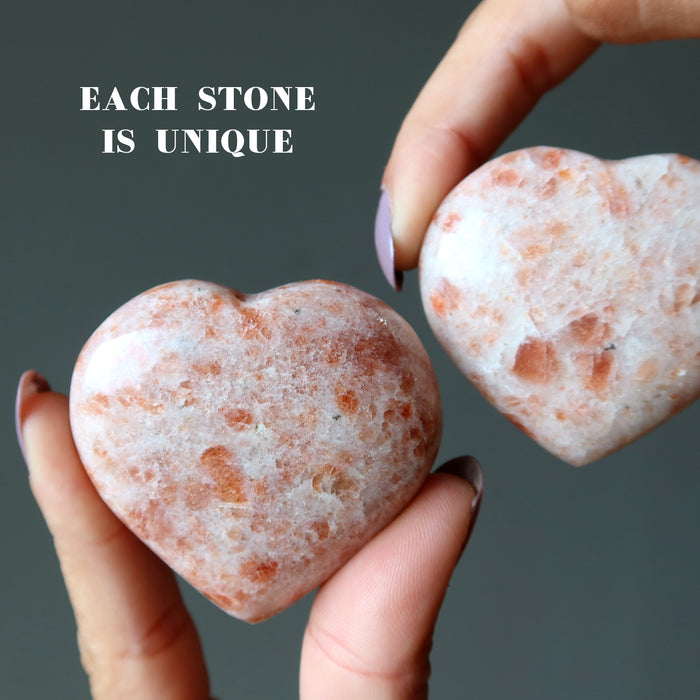 hands holding 2 Sunstone Hearts