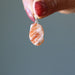 hand holding Sunstone Pendant Drop pendant