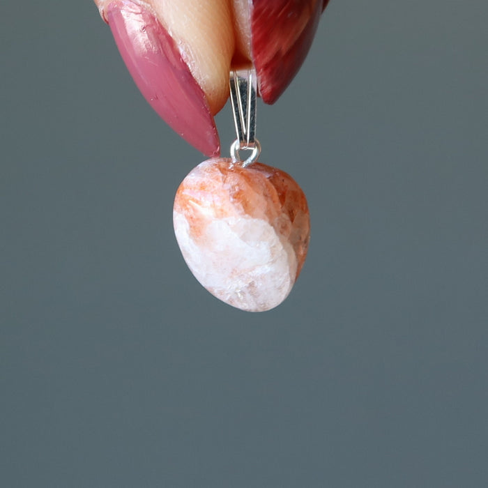 hand holding Sunstone Pendant Drop pendant